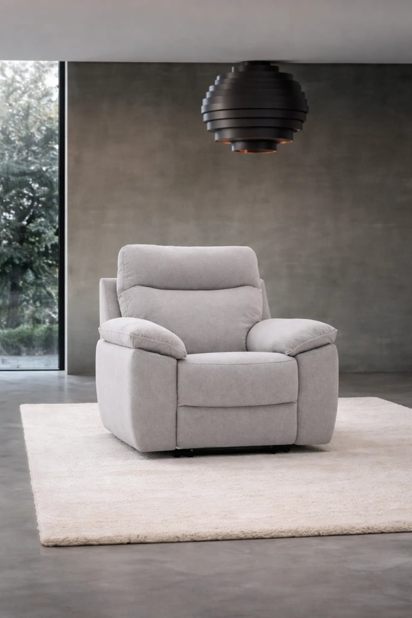 Sillón relax eléctrico Vissuto Kenia en salón moderno con alfombra y ventanal