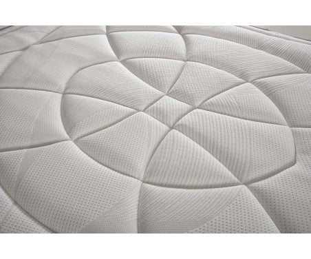 Vista superior del colchón Vissuto Smart con diseño acolchado circular en tejido blanco premium